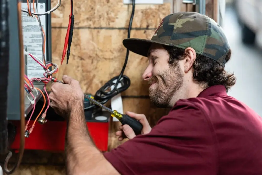 HVAC technician repairing a gas furnace.